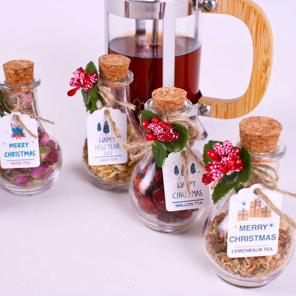 Christmas Tea favors for guests, Personalized Bulk Christmas gifts, Happy Holiday favors, Loose Leaf Tea Favor, Tea jars, Unique gift, Herbal Tea gifts Items designed by Happy Times Favors, a handmade gift shop. These glass cork vials/jars are filled with 11 different tea. Ideal for Christmas, Noel, New Year, Happy Holiday party gifts. Personalized Christmas Gifts, Custom Gifts for Christmas.